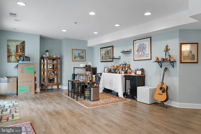 bar with baseboards, wood finished floors, visible vents, and recessed lighting