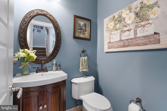 half bath featuring toilet and vanity