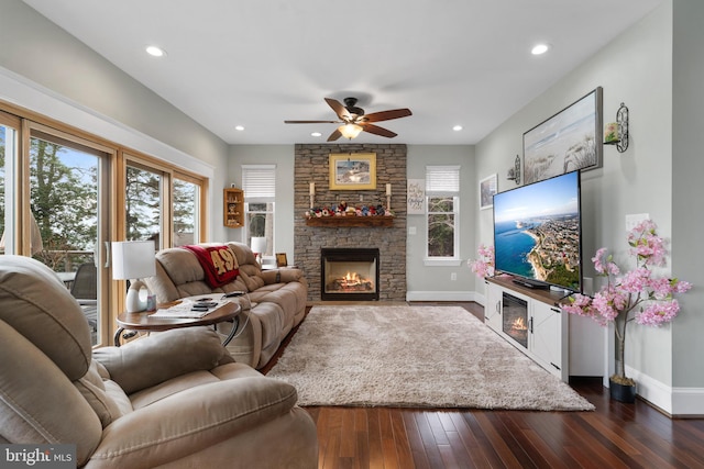 living room with dark wood-style floors, a fireplace, baseboards, and recessed lighting