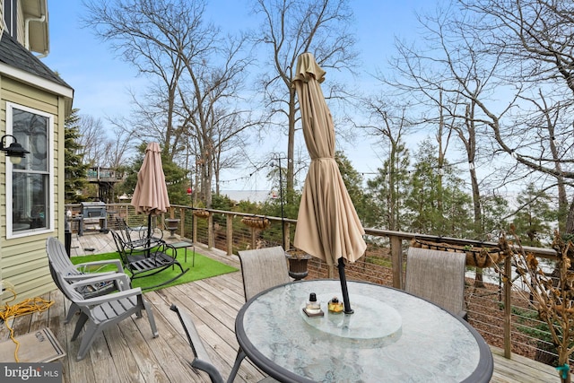 wooden deck featuring outdoor dining area