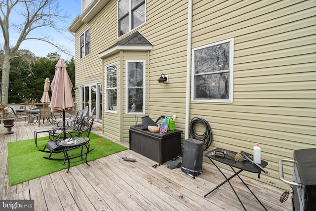 wooden terrace with outdoor dining area