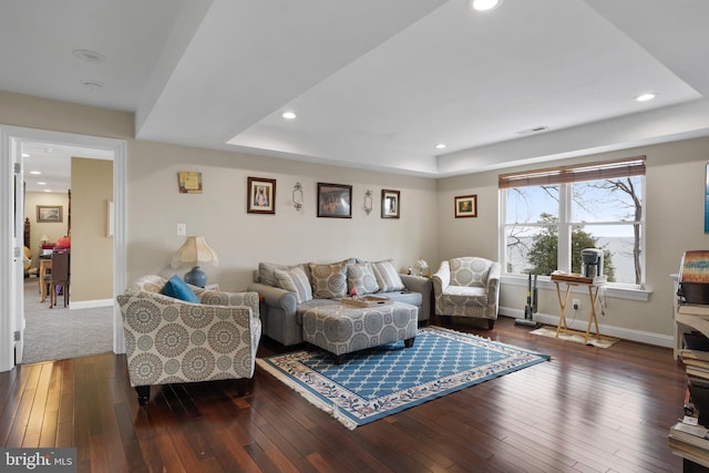 living room with dark wood-style floors, recessed lighting, visible vents, and baseboards