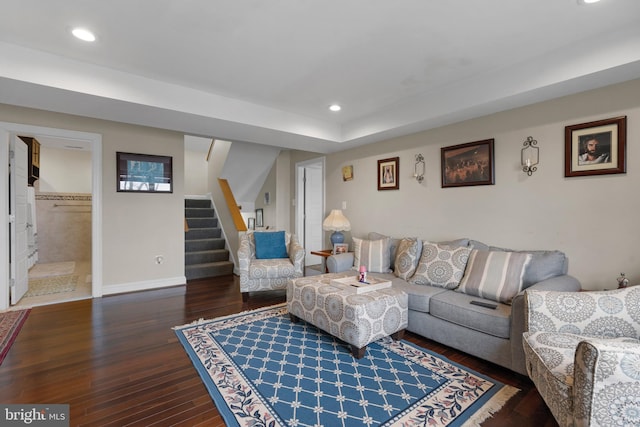 living area featuring stairs, dark wood-type flooring, baseboards, and recessed lighting