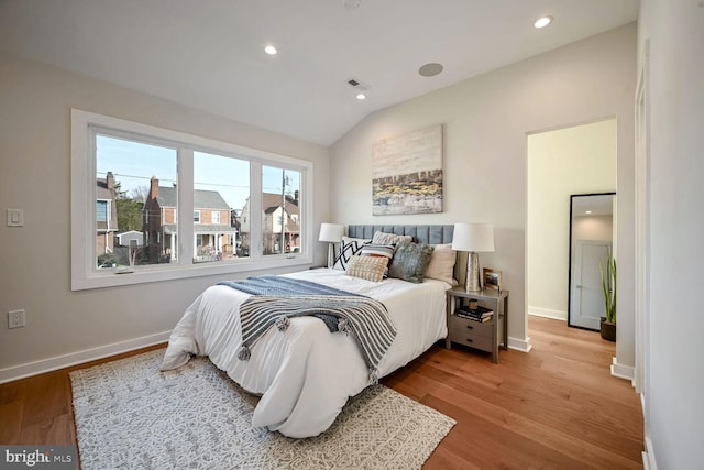 bedroom featuring vaulted ceiling and hardwood / wood-style floors