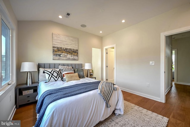 bedroom with dark hardwood / wood-style flooring and vaulted ceiling