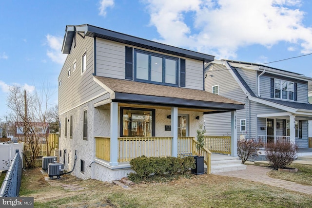 view of front of house with central AC unit and covered porch