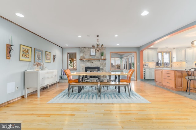 dining area with a fireplace and light hardwood / wood-style floors