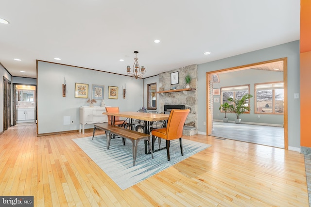 dining area with an inviting chandelier and light wood-type flooring