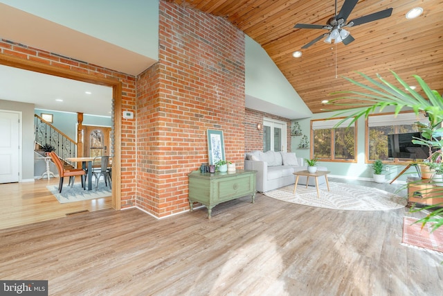 unfurnished living room featuring ceiling fan, high vaulted ceiling, wood ceiling, and light hardwood / wood-style floors