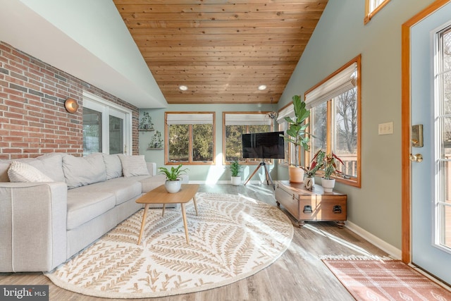 living room featuring wood ceiling, lofted ceiling, wood-type flooring, and brick wall