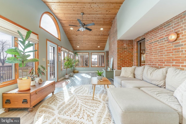 living room with ceiling fan, high vaulted ceiling, brick wall, wooden ceiling, and light wood-type flooring