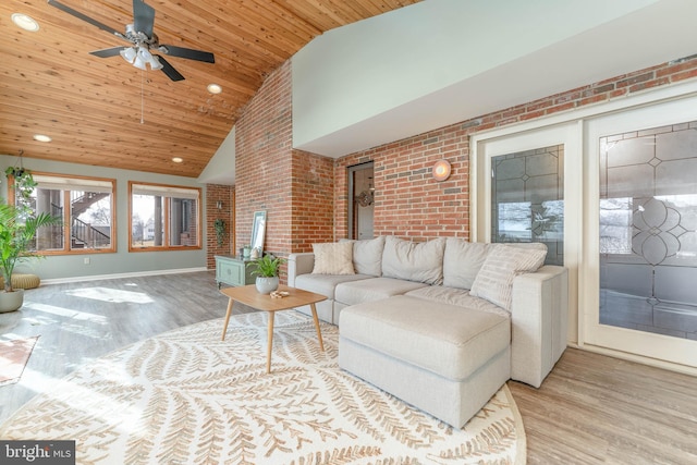 living room featuring brick wall, high vaulted ceiling, ceiling fan, light hardwood / wood-style floors, and wooden ceiling