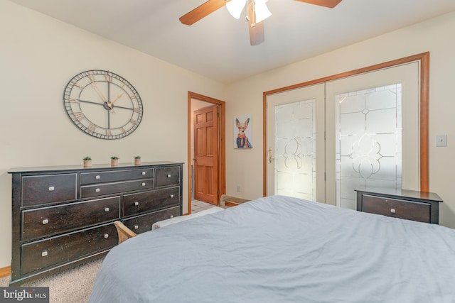 bedroom featuring ceiling fan, ensuite bath, and light carpet