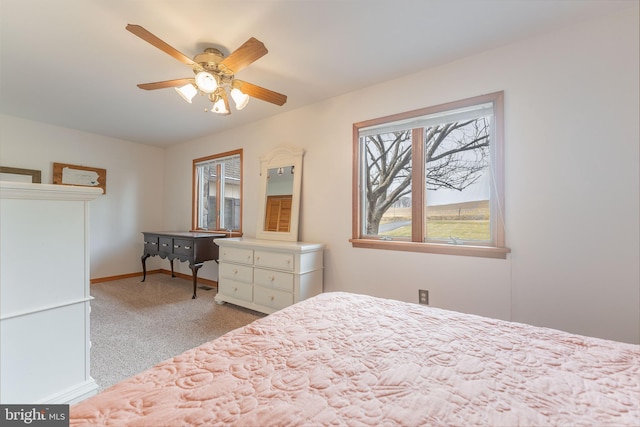 bedroom featuring light colored carpet and ceiling fan