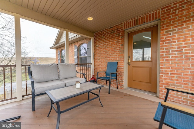 wooden deck featuring an outdoor living space and covered porch