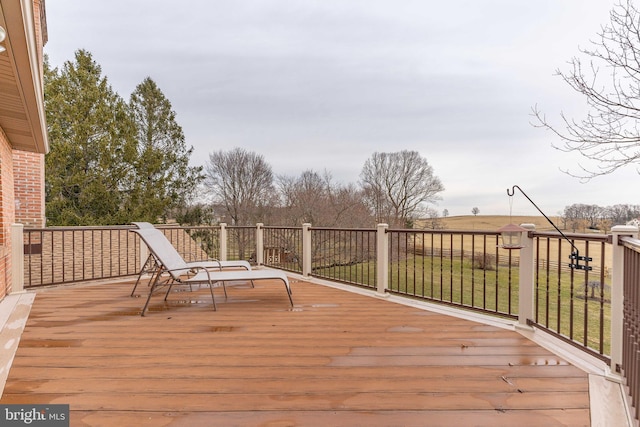 wooden deck featuring a lawn