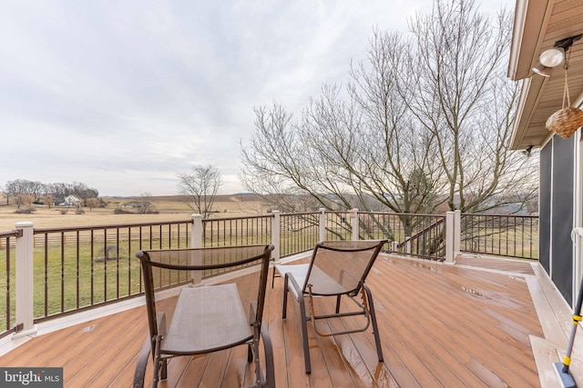 deck featuring a yard and a rural view