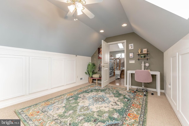 office featuring vaulted ceiling, light colored carpet, and ceiling fan