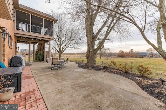 view of patio with grilling area and a sunroom