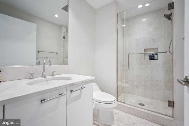 bathroom featuring walk in shower, vanity, toilet, and tile patterned flooring