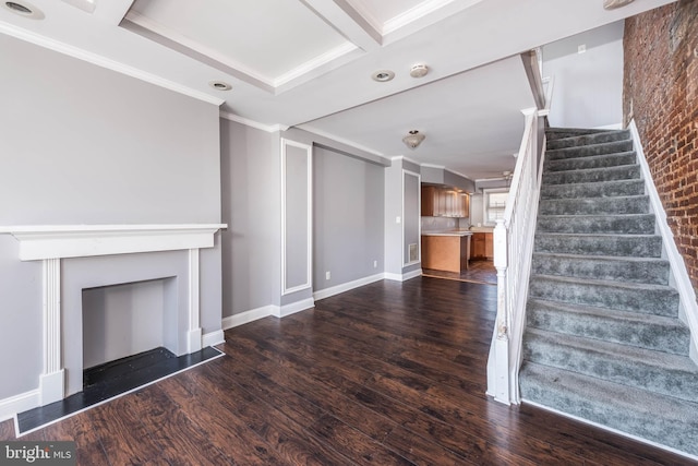 unfurnished living room featuring coffered ceiling, ornamental molding, dark hardwood / wood-style floors, and beamed ceiling