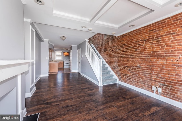 unfurnished living room featuring ornamental molding, brick wall, dark hardwood / wood-style floors, and beam ceiling