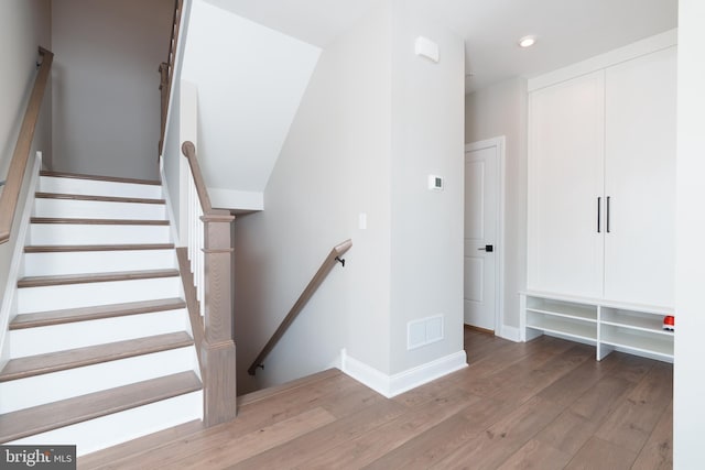 stairway with hardwood / wood-style flooring