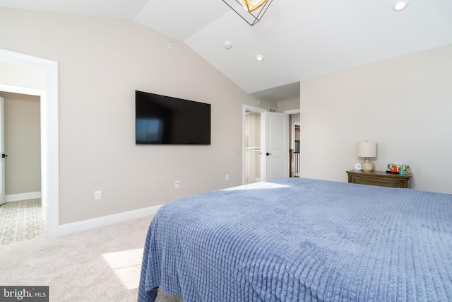 bedroom featuring light colored carpet and vaulted ceiling