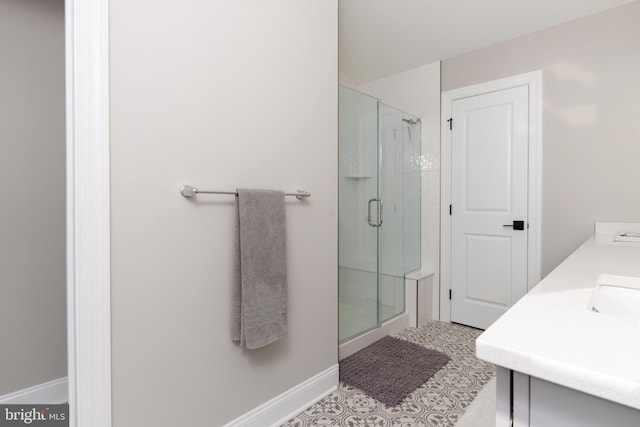 bathroom featuring vanity and a shower with door