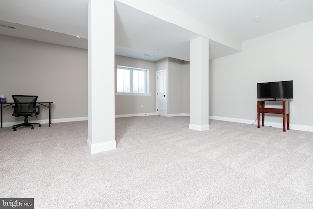 basement featuring light colored carpet