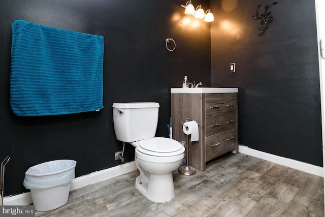 bathroom with vanity, hardwood / wood-style flooring, and toilet