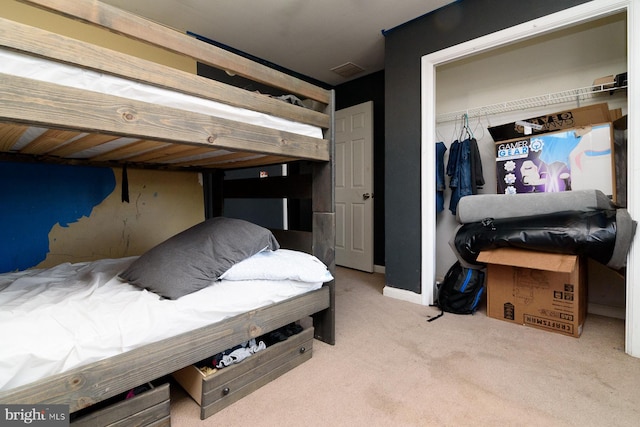 bedroom featuring light colored carpet and a closet