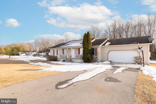 ranch-style home with a garage, covered porch, and solar panels