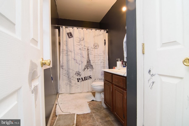 bathroom with vanity, toilet, curtained shower, and tile patterned flooring