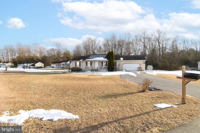 view of front of home with a garage and solar panels