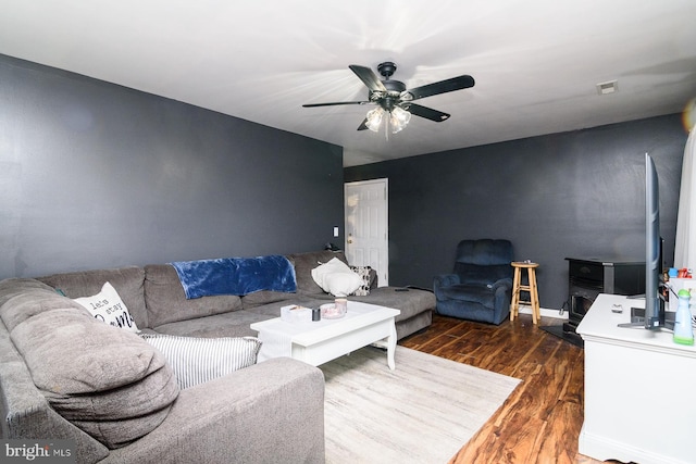 living room with ceiling fan and dark hardwood / wood-style flooring