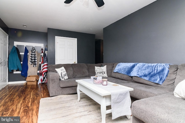 living room with ceiling fan and dark hardwood / wood-style floors