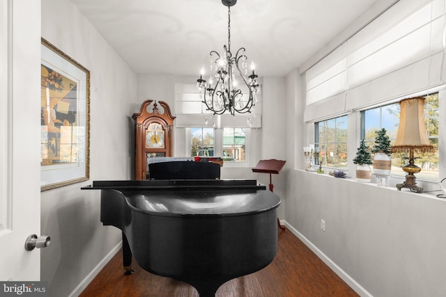 miscellaneous room with dark hardwood / wood-style flooring and a notable chandelier