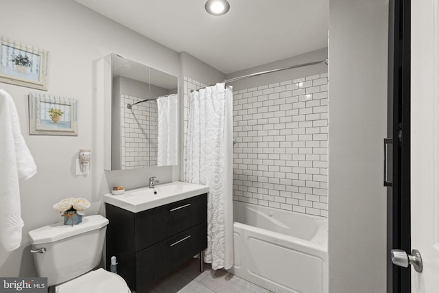 full bathroom featuring vanity, shower / bathtub combination with curtain, and toilet