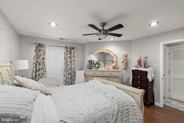 bedroom with dark hardwood / wood-style floors and ceiling fan