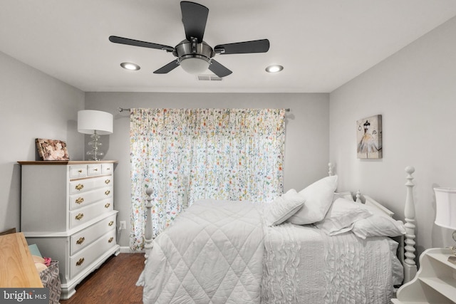 bedroom with dark hardwood / wood-style flooring and ceiling fan