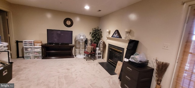 living room with carpet, a fireplace with flush hearth, visible vents, and recessed lighting