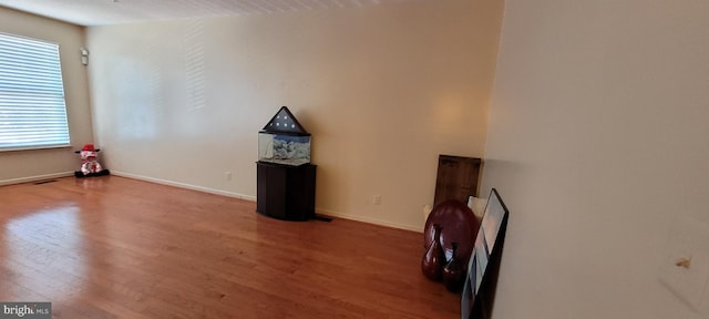 interior space featuring visible vents, baseboards, and wood finished floors