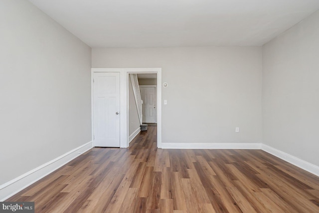 empty room featuring dark wood-type flooring