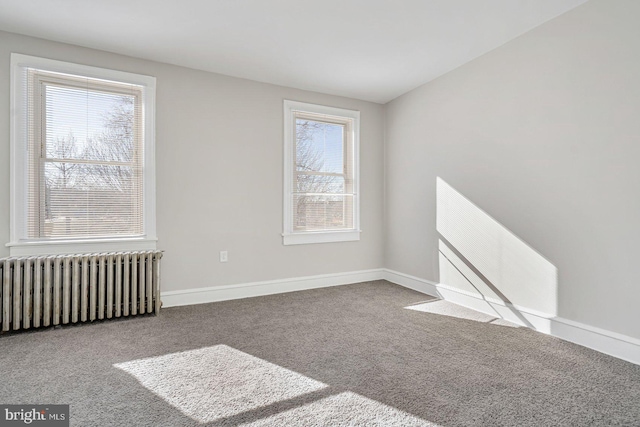 empty room with radiator and carpet flooring