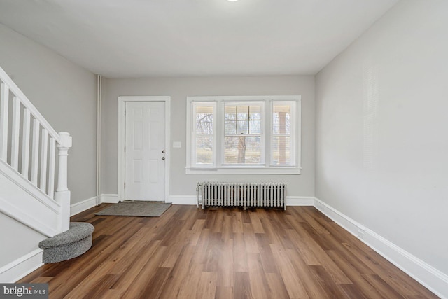 foyer with hardwood / wood-style flooring and radiator