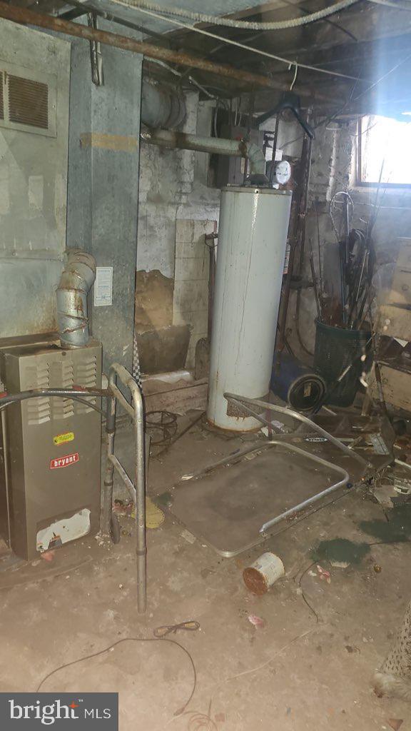 utility room featuring gas water heater and heating unit