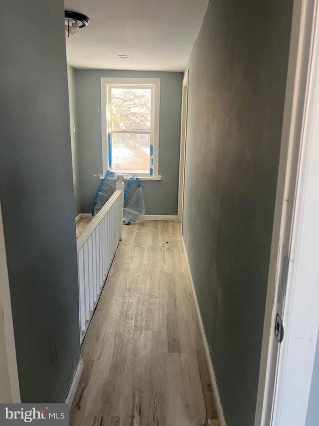 corridor with light hardwood / wood-style flooring