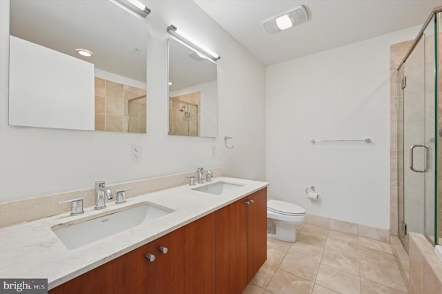 bathroom featuring vanity, toilet, an enclosed shower, and tile patterned flooring