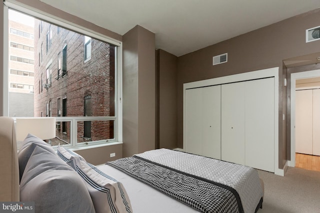 carpeted bedroom with a closet